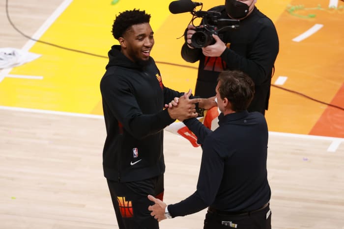 Donovan Mitchell (left) and head coach Quin Snyder (right) celebrate after the Jazz opening series win